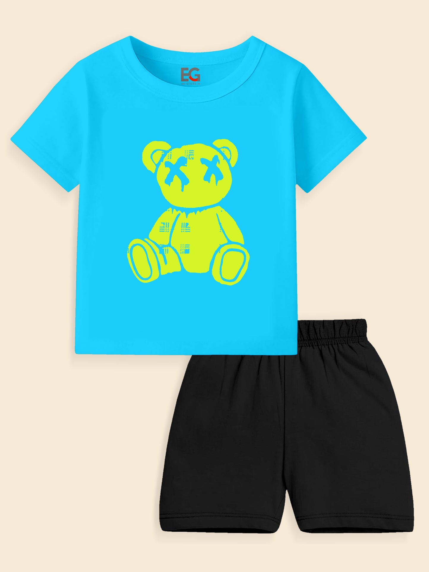 Blue kids t-shirt with yellow teddy bear print and black shorts set on beige background