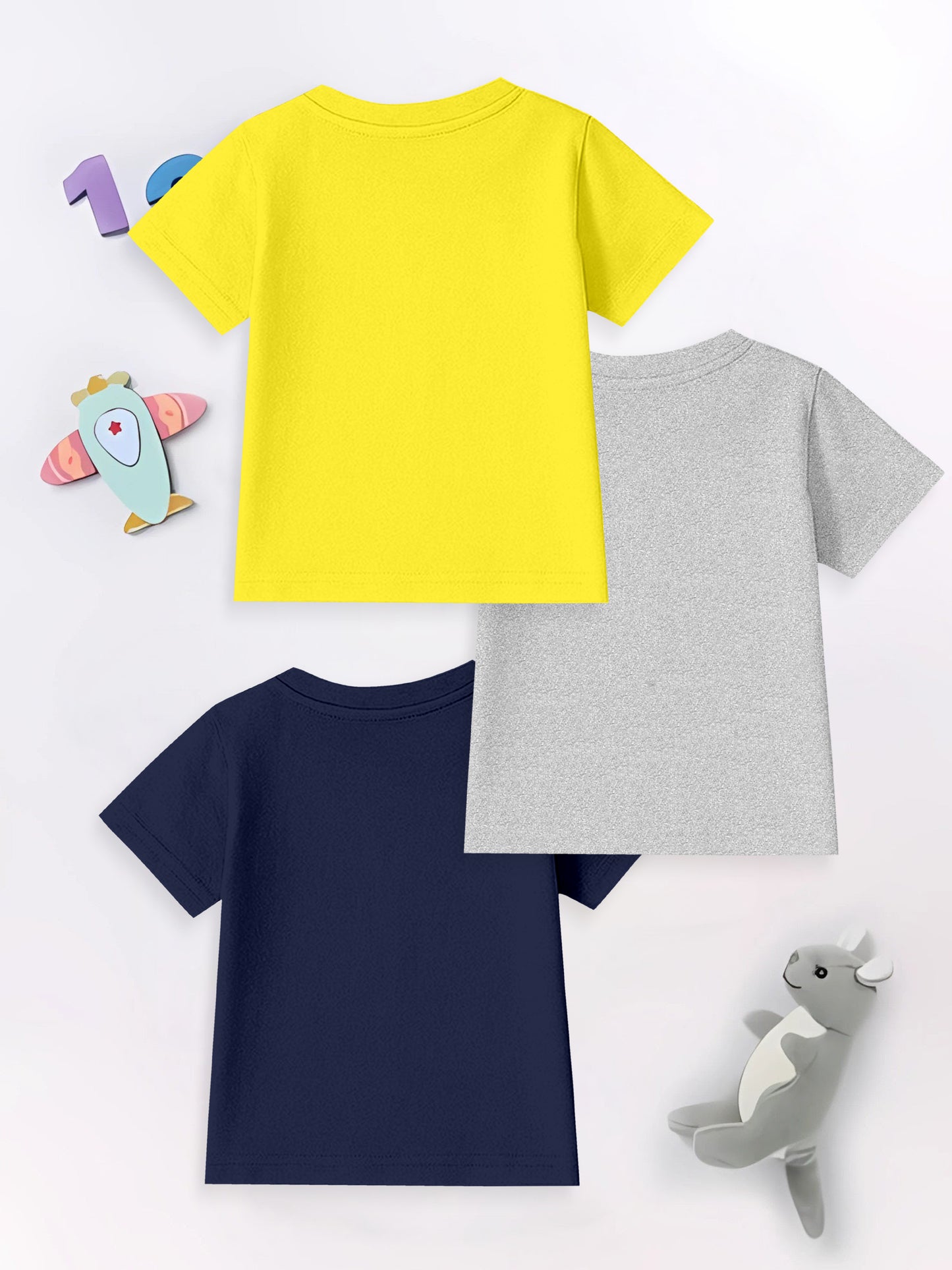 Three plain short sleeve kids t-shirts in yellow, gray, and navy with plush toys