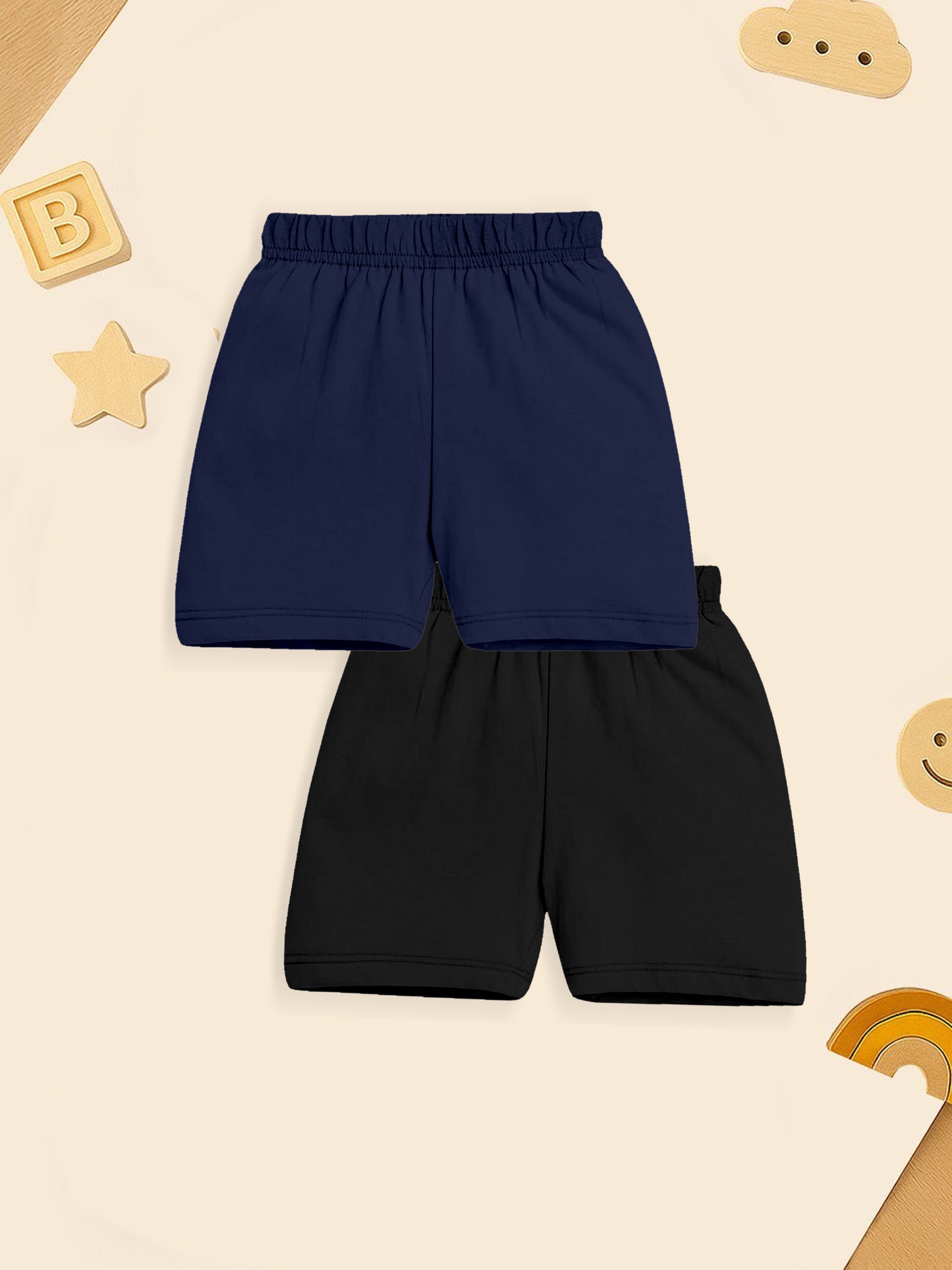 Navy blue and black kids shorts set with elastic waistband on a beige background with toys