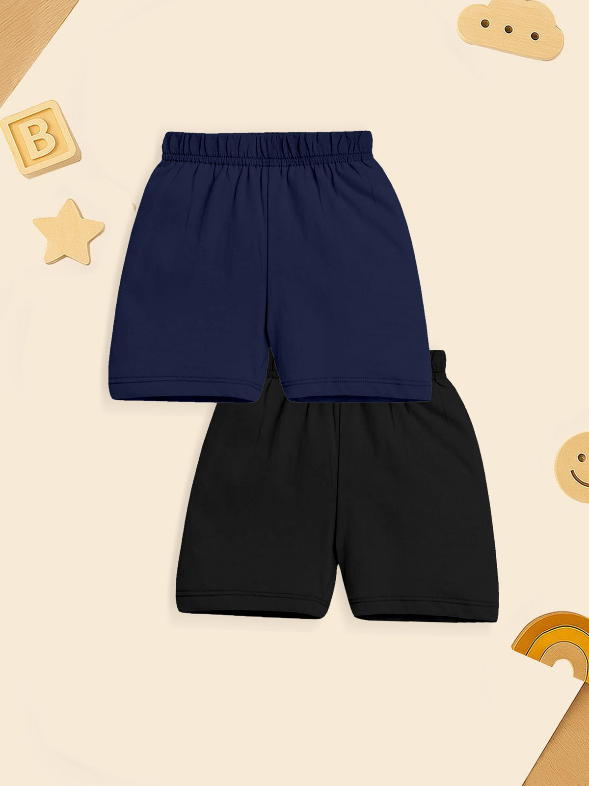 Navy blue and black kids shorts set with elastic waistband on a beige background with toys