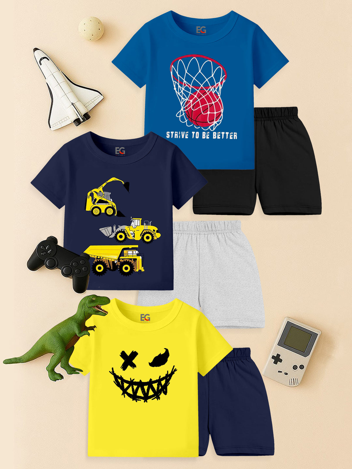 Kids' short sleeve graphic t-shirt and shorts sets with basketball hoop, construction vehicles, and smiley face prints, styled flat lay with toys.