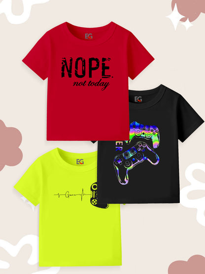 Three kids' t-shirts with gamer graphics and funny text, arranged on a patterned background.