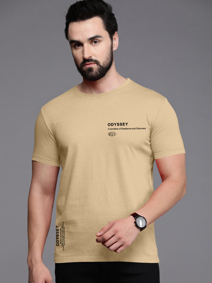 Man wearing a beige ODYSSEY t-shirt with black text, casual minimal style