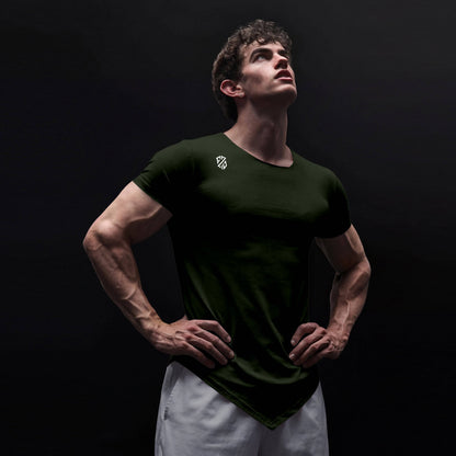 Athletic man in black fitted t-shirt with logo, posing confidently against dark background