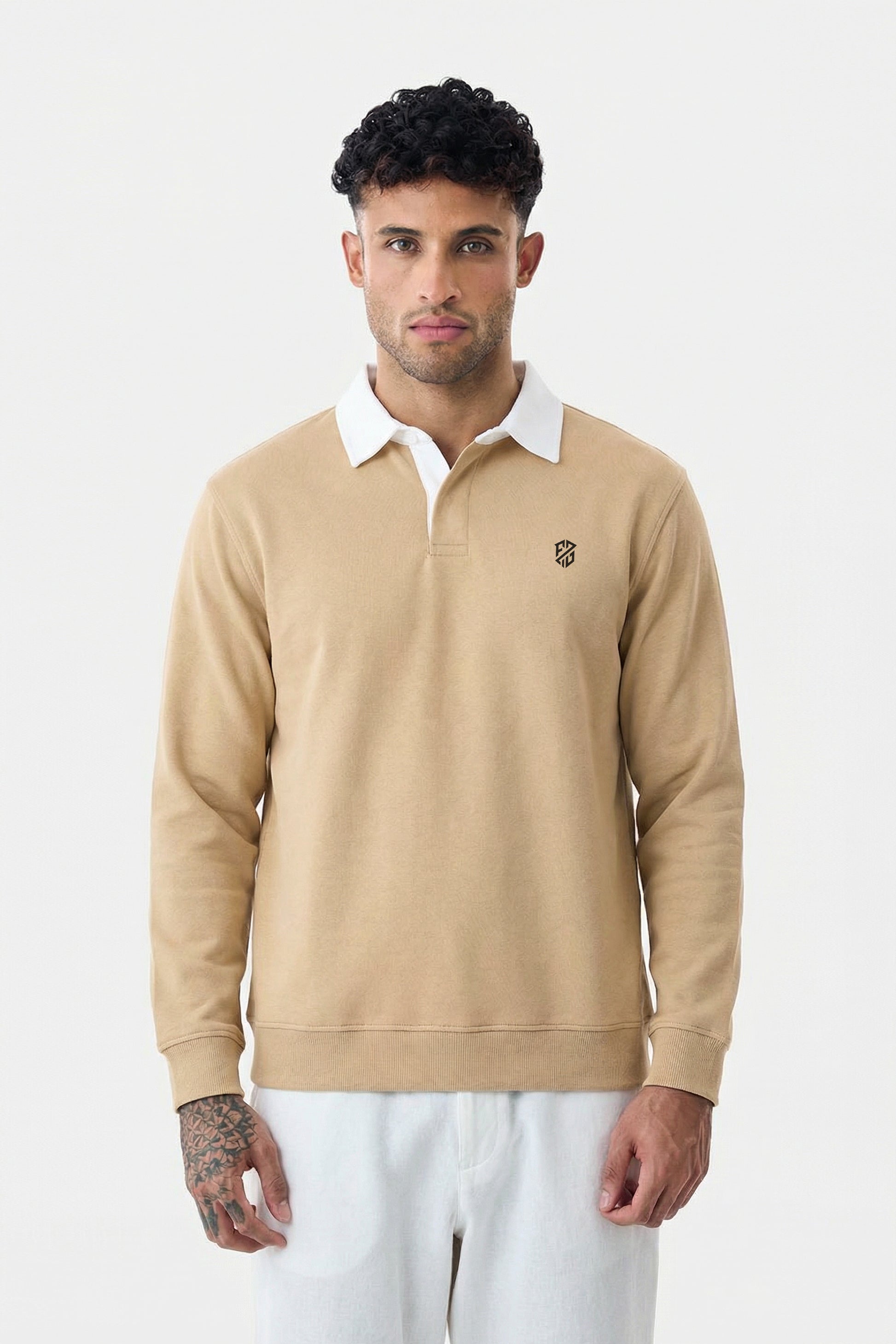 Man wearing beige long sleeve rugby polo shirt with white collar, casual style
