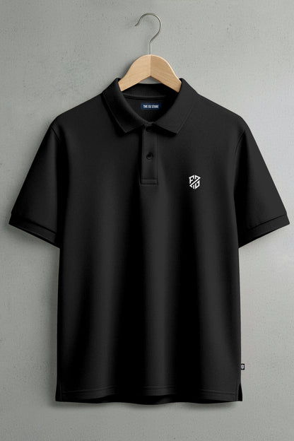Black polo shirt with white embroidered logo on chest, hanging on wooden hanger