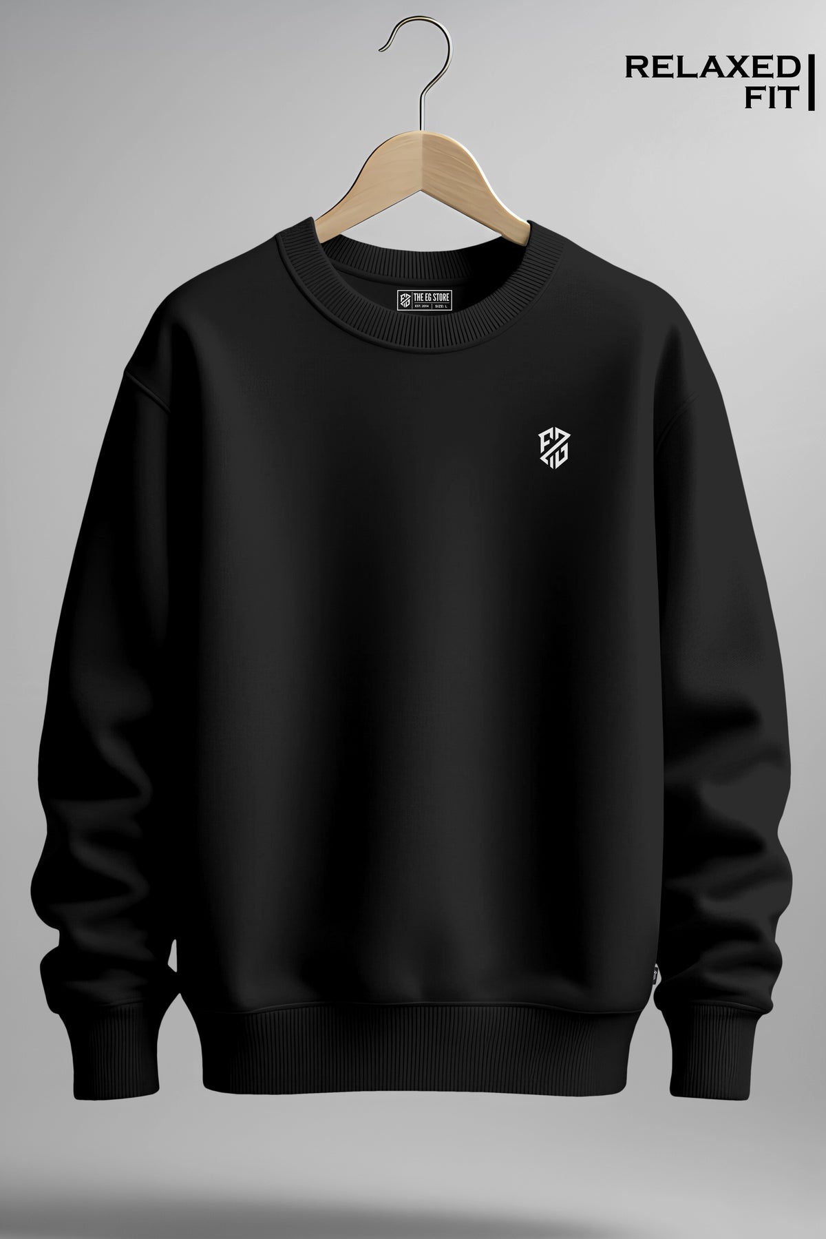 Black relaxed fit crewneck sweatshirt with small white geometric logo on chest, hanging on hanger
