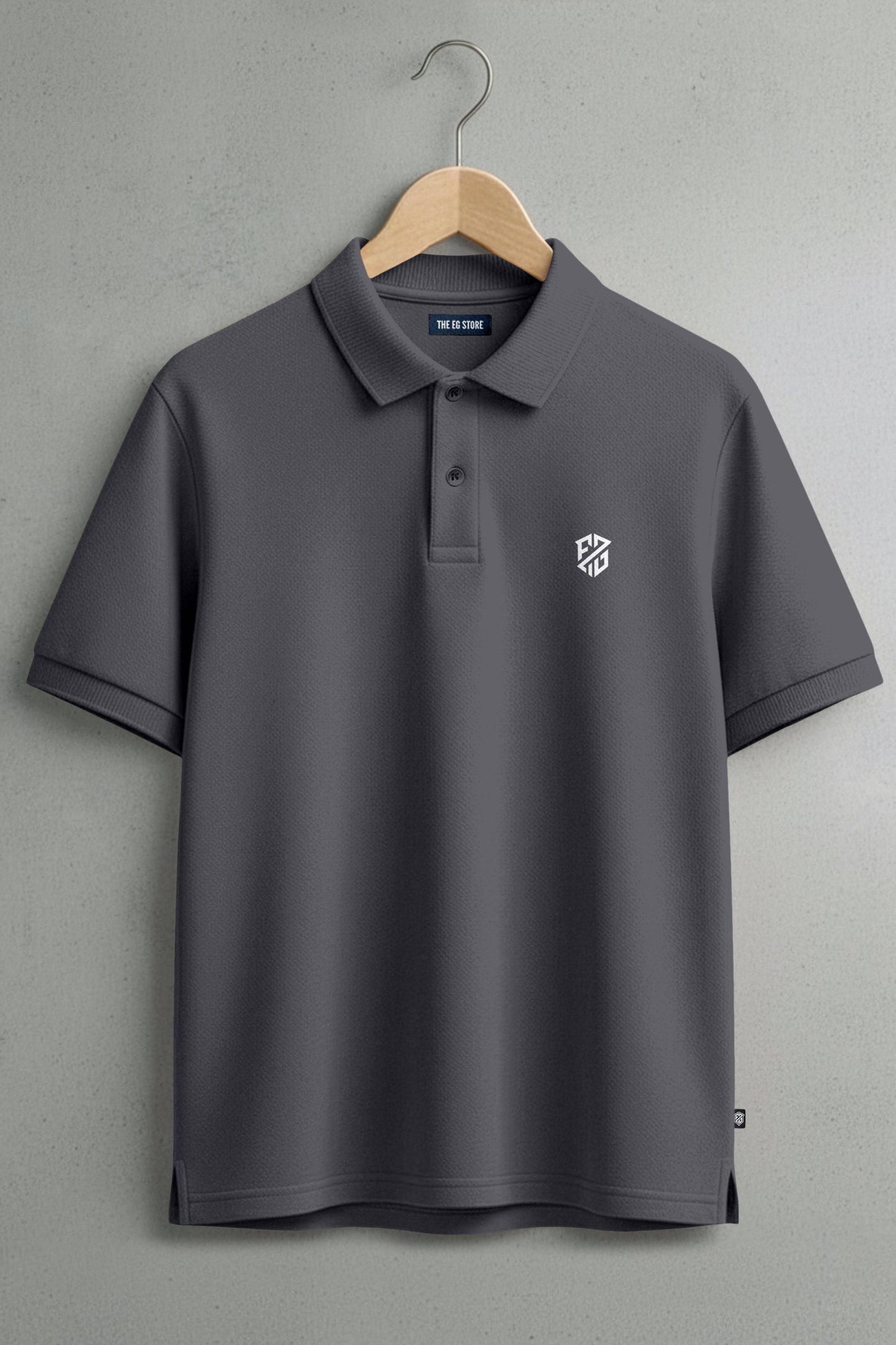 Dark grey polo shirt with short sleeves, button collar, and white chest logo on hanger