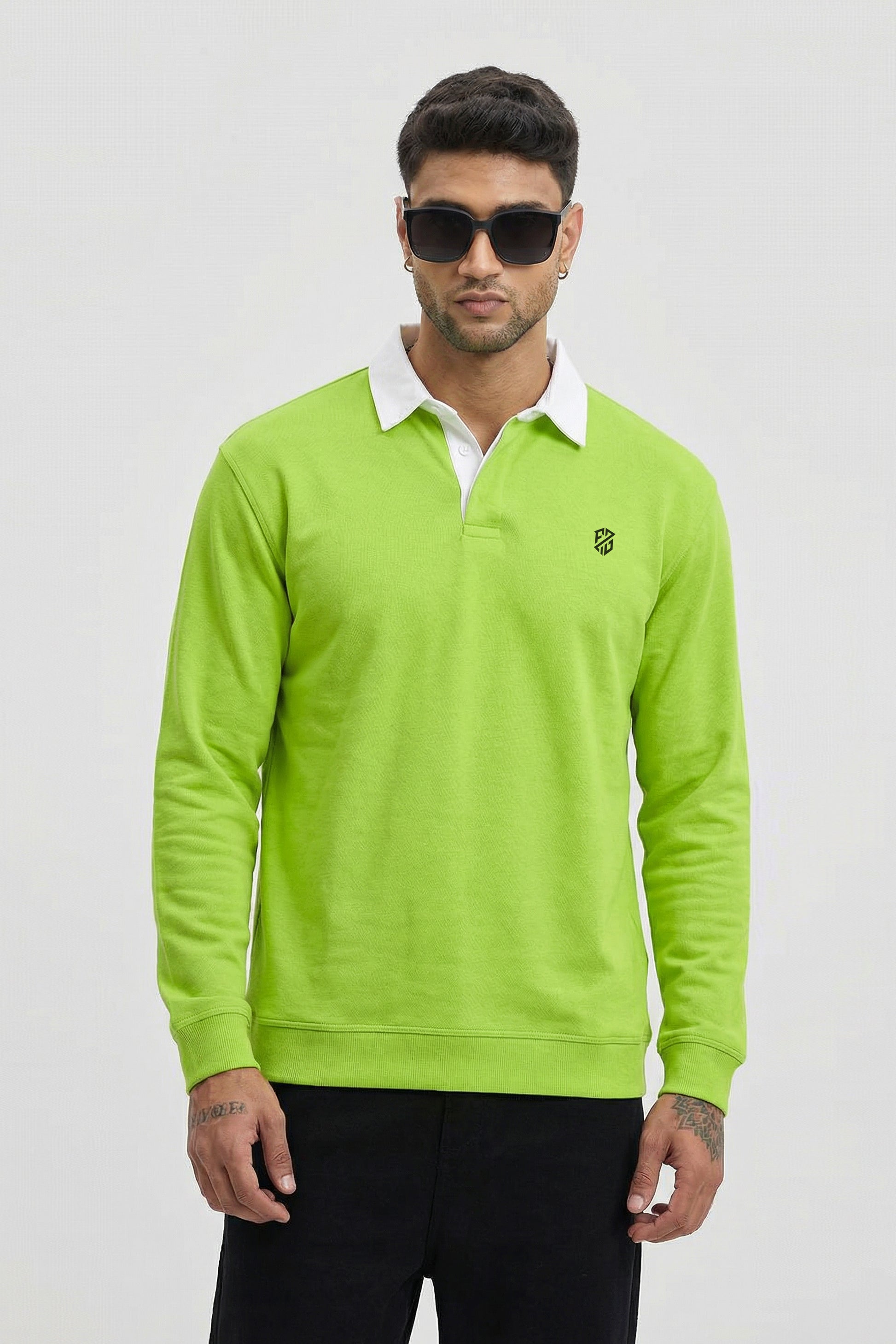 Man wearing neon green long sleeve rugby shirt with white collar and black embroidered logo