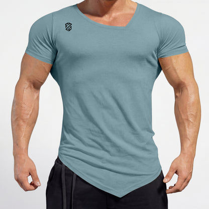 Athletic man wearing fitted light blue V-neck t-shirt and black shorts, standing outdoors