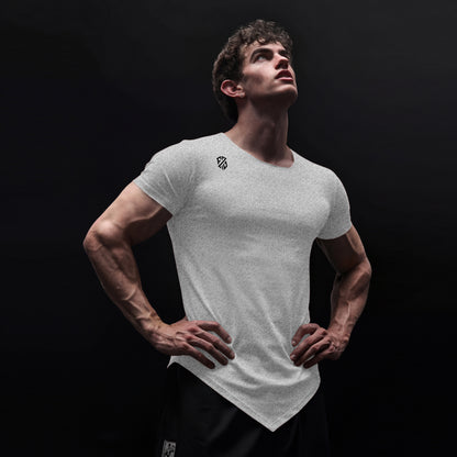 Athletic man in white fitted t-shirt with logo and black shorts against dark background
