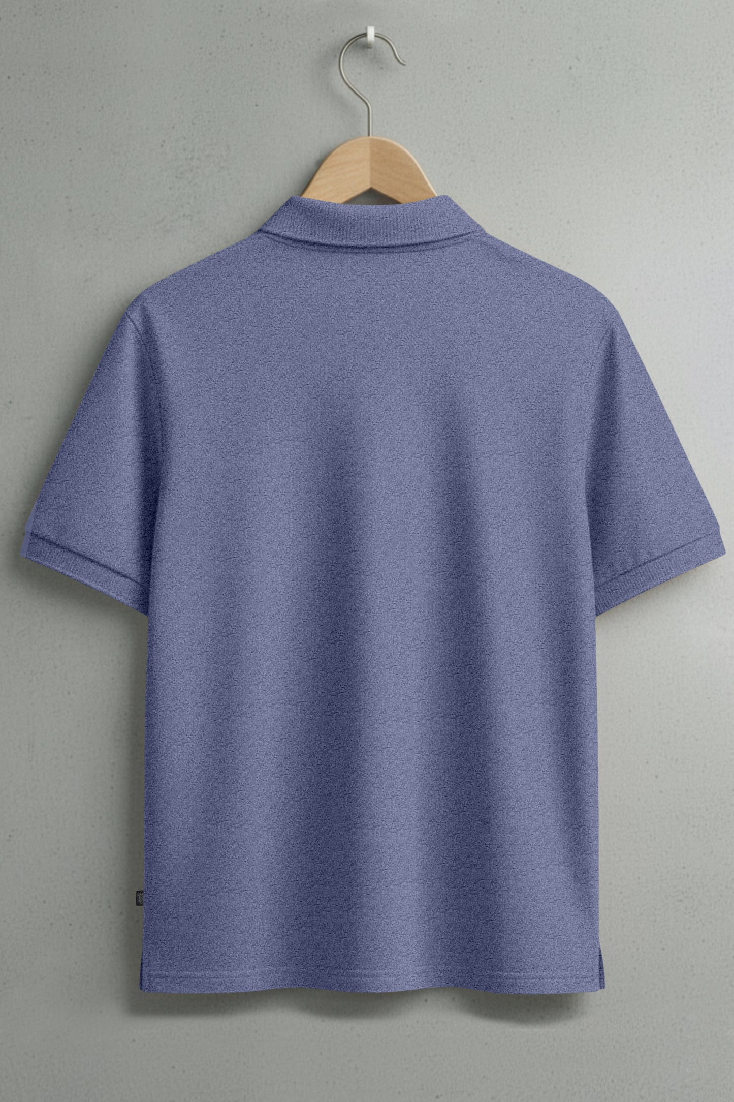Back view of a plain blue short sleeve polo shirt on a hanger against a light wall