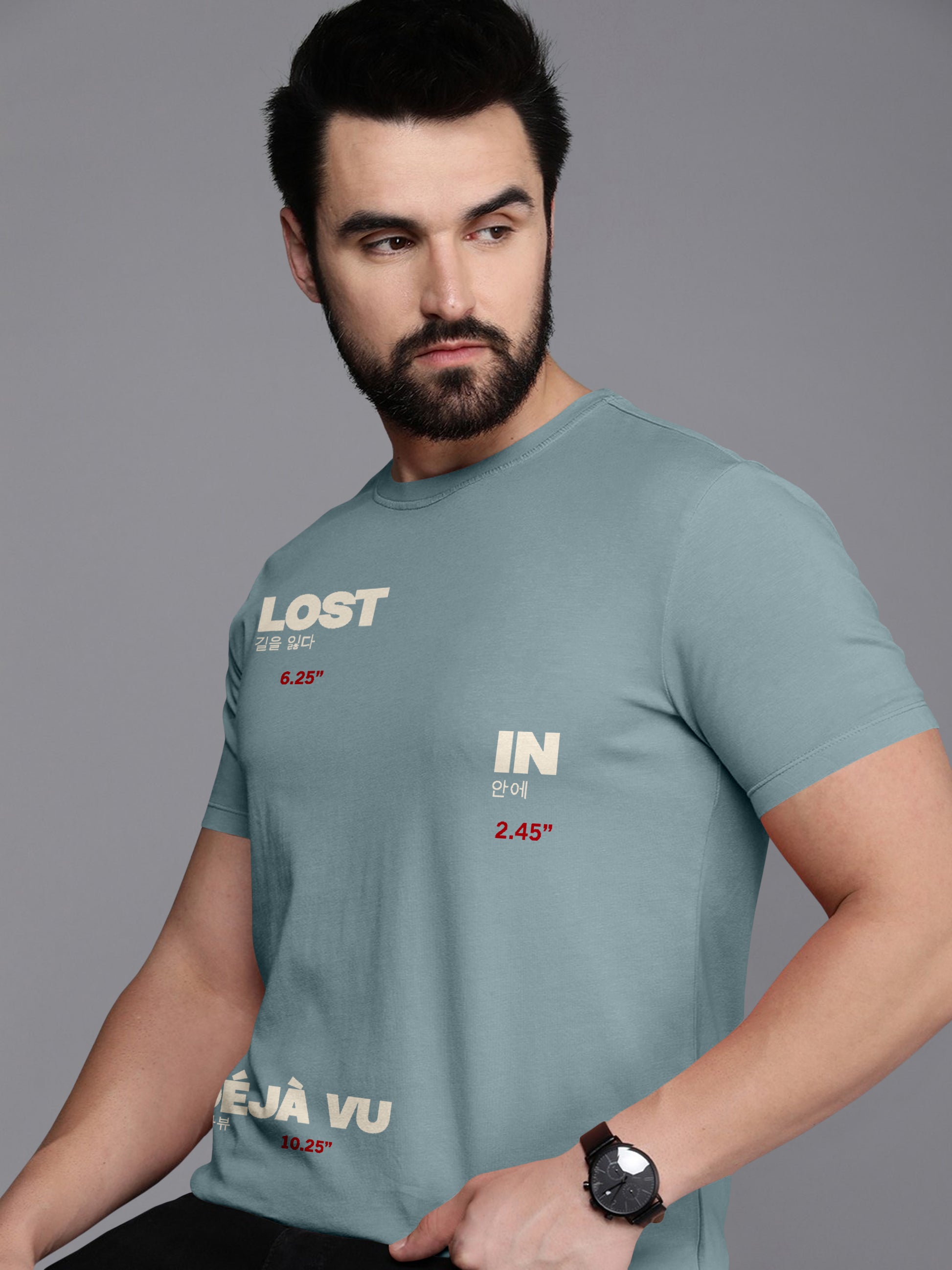 Man wearing light blue graphic t-shirt with 'LOST IN DÉJÀ VU' text and Korean characters.