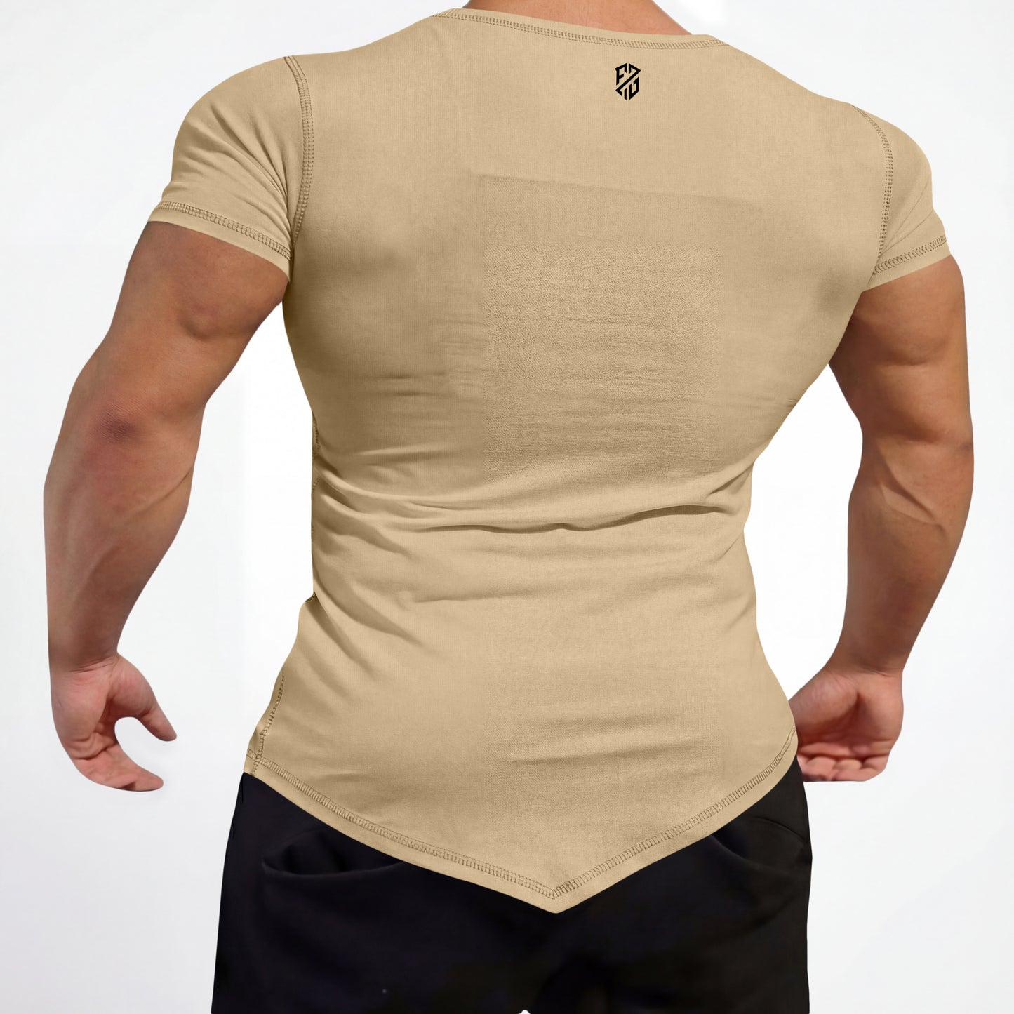 Man wearing fitted beige short sleeve t-shirt with pointed hem and black pants, back view