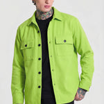 Man wearing neon green button-up overshirt with pockets, black shirt, and beige cap