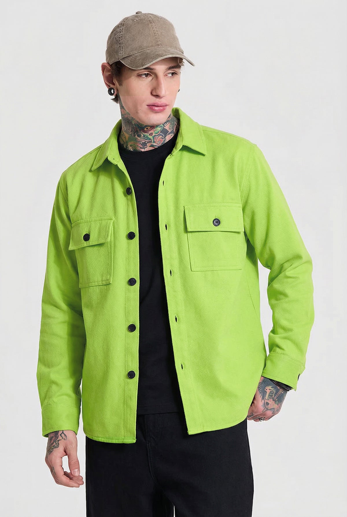 Man wearing neon green button-up overshirt with pockets, black shirt, and beige cap