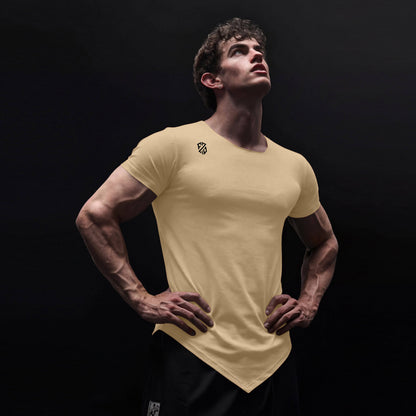 Athletic man wearing fitted beige V-hem t-shirt with logo, standing against dark background