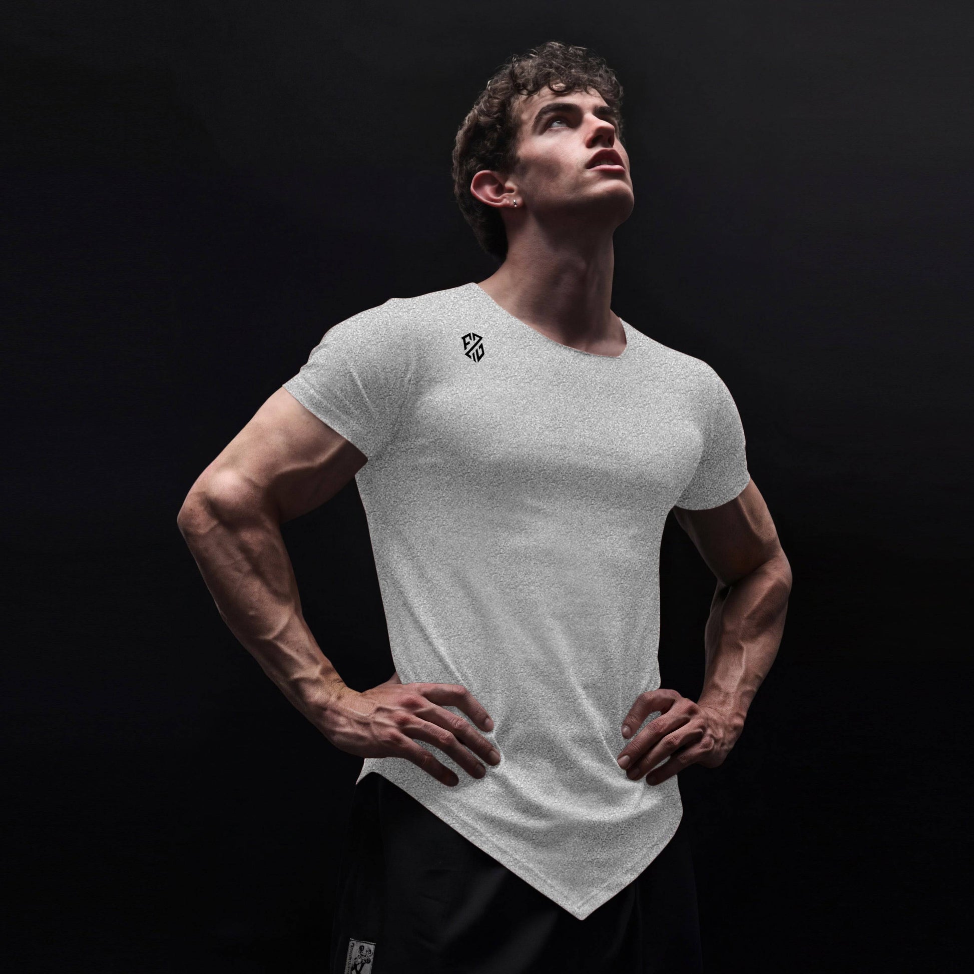 Athletic man modeling a white fitted t-shirt with geometric logo, against black background