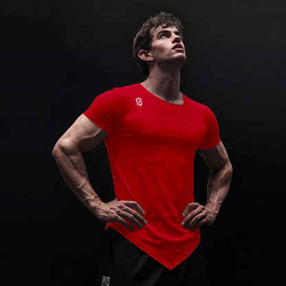 Athletic man in red fitted t-shirt with logo, posing confidently against black background
