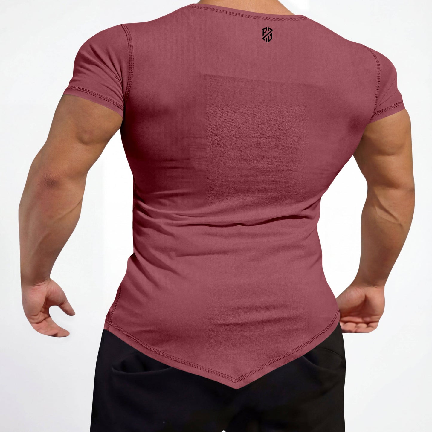Man wearing fitted maroon short sleeve shirt with pointed hem and black athletic pants