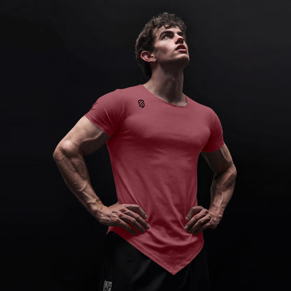 Athletic man in fitted red V-cut hem t-shirt with logo, posing against black background