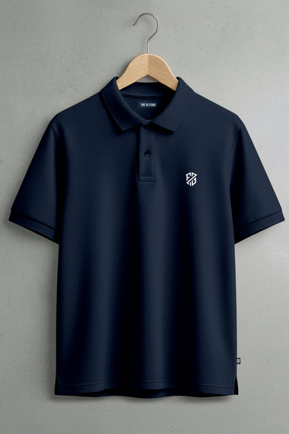 Navy blue polo shirt with white embroidered logo on chest, displayed on wooden hanger