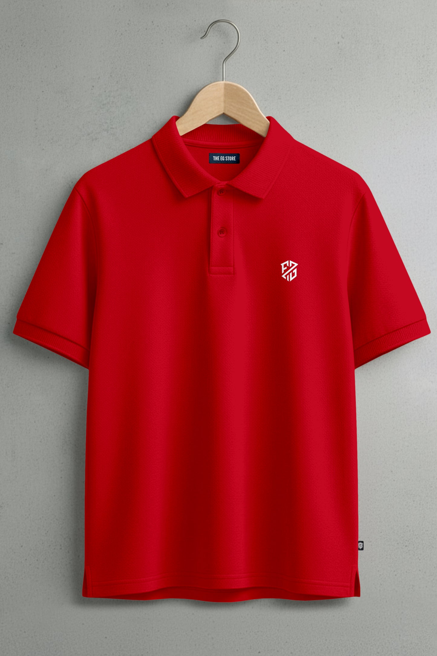Red short sleeve polo shirt with white logo on chest, hanging on wooden hanger