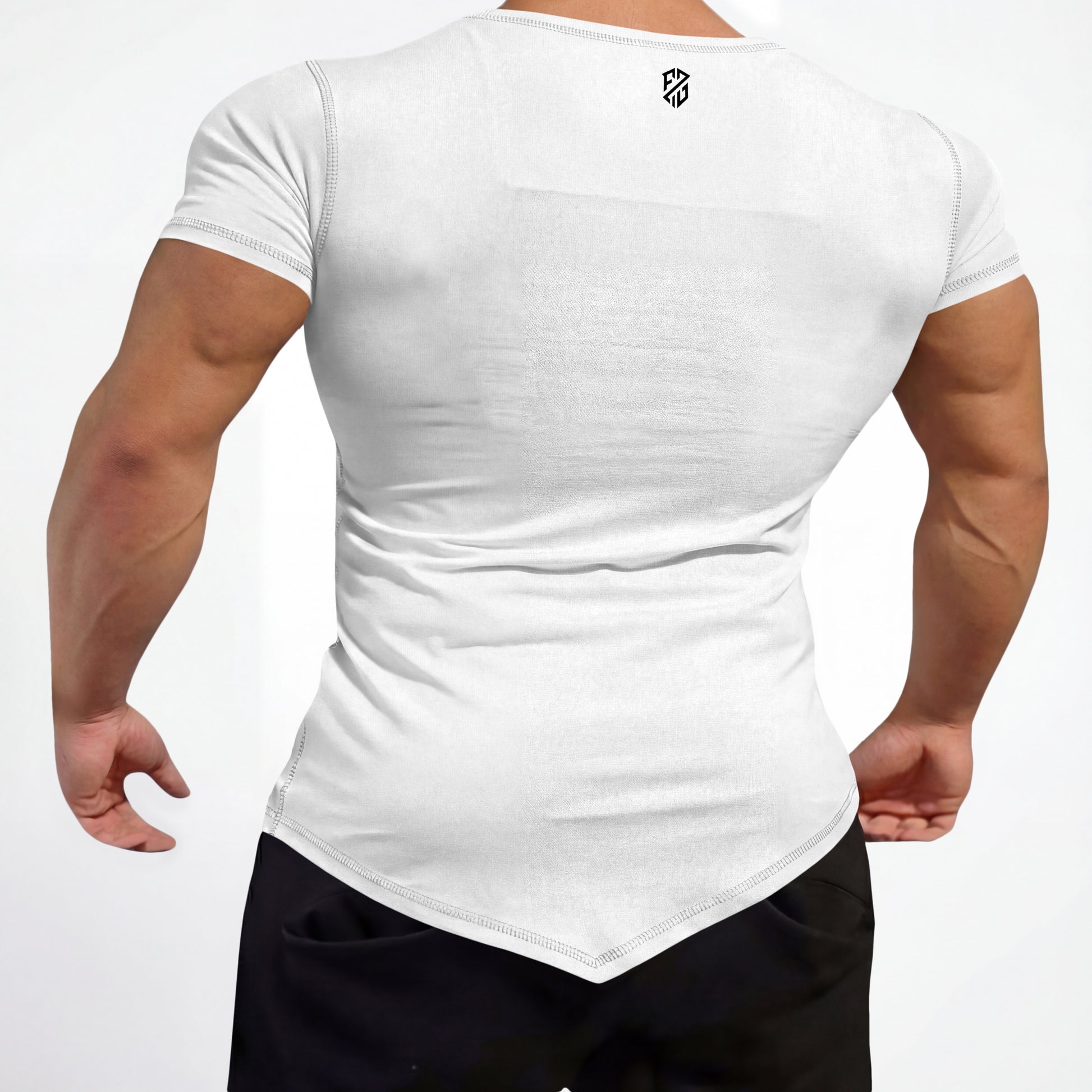 Back view of a man in a fitted white short sleeve t-shirt with asymmetrical hem