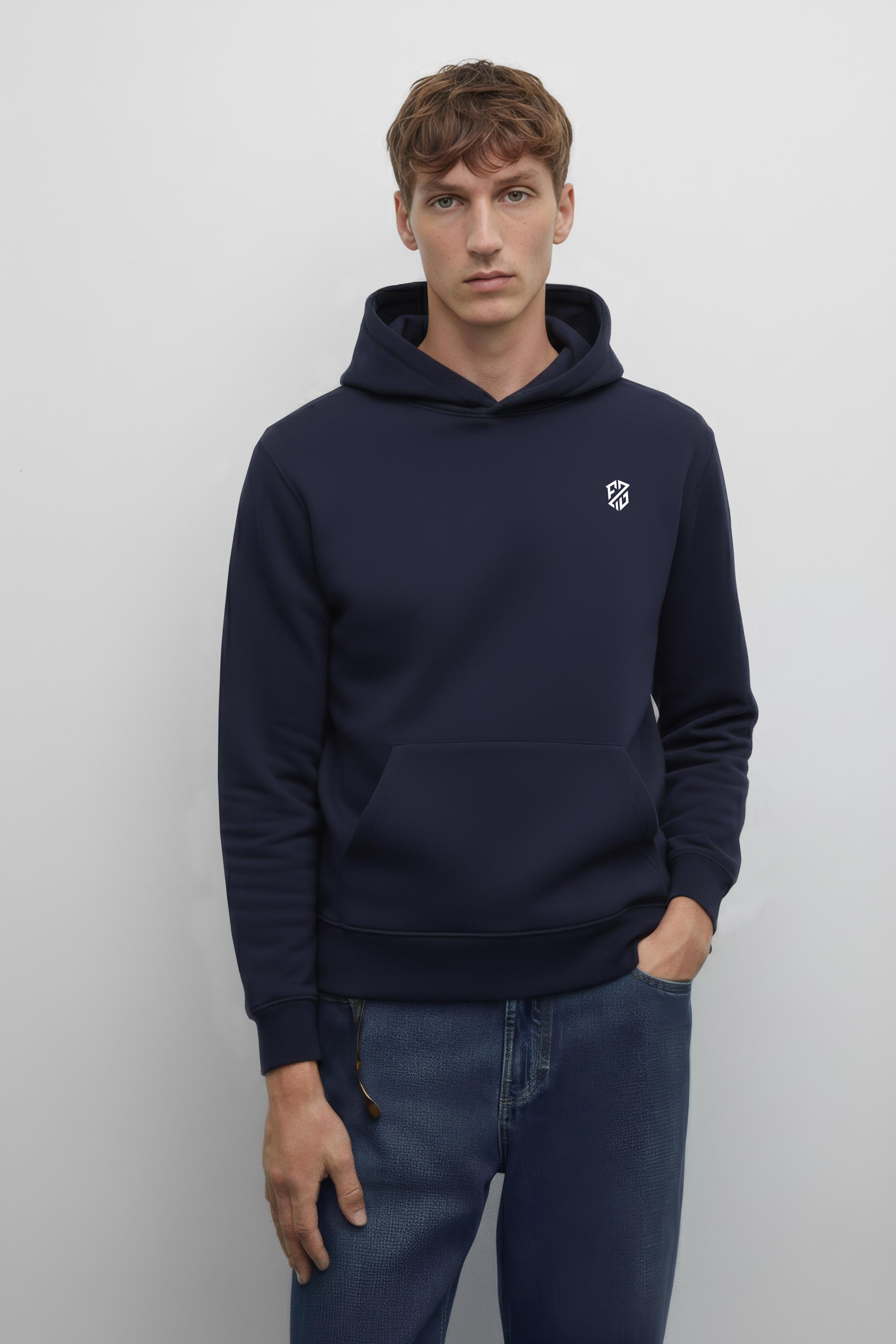 Male model in navy blue hoodie with white chest logo and front pocket, casual jeans style