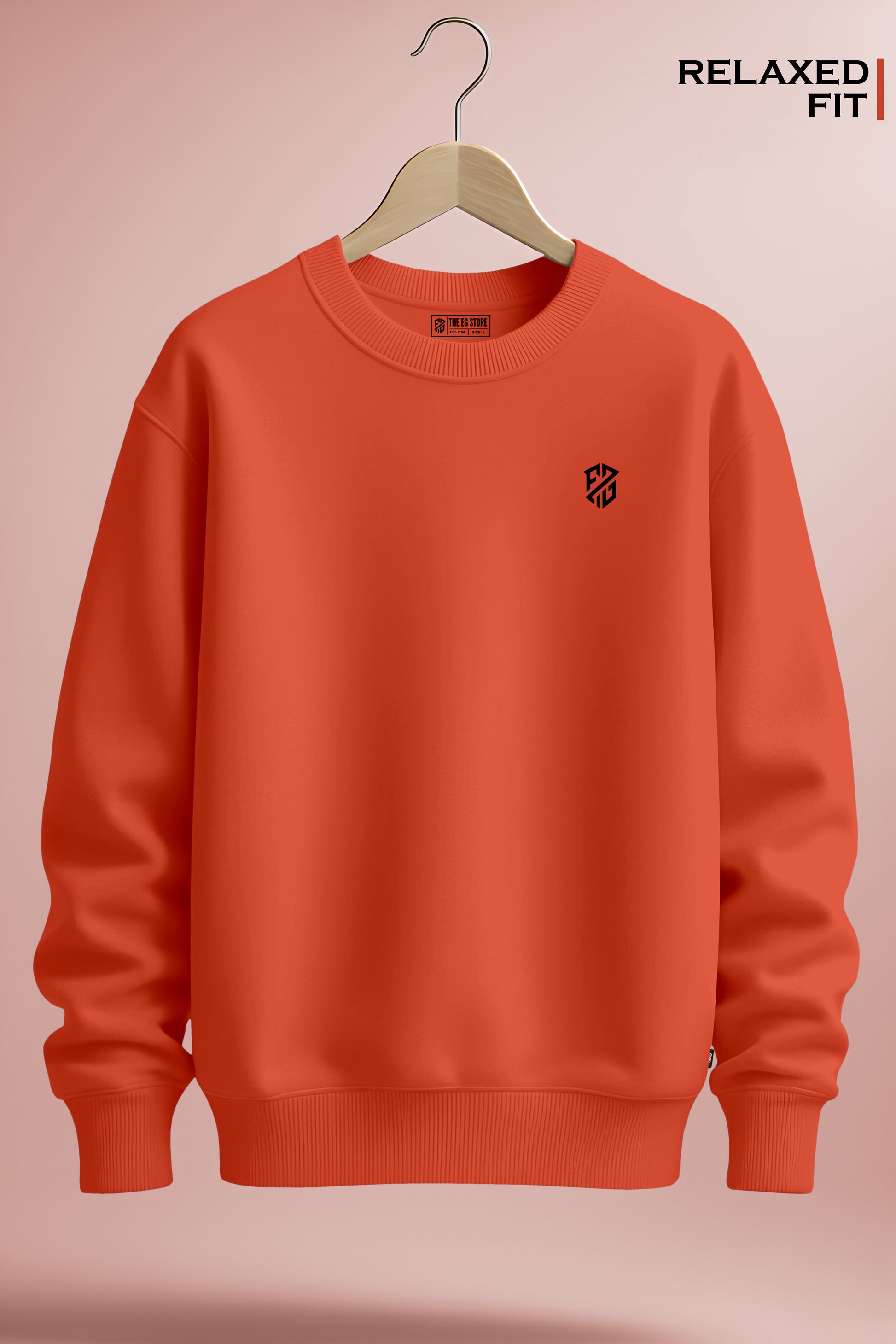 Relaxed fit orange crewneck sweatshirt with minimalist chest logo on wooden hanger