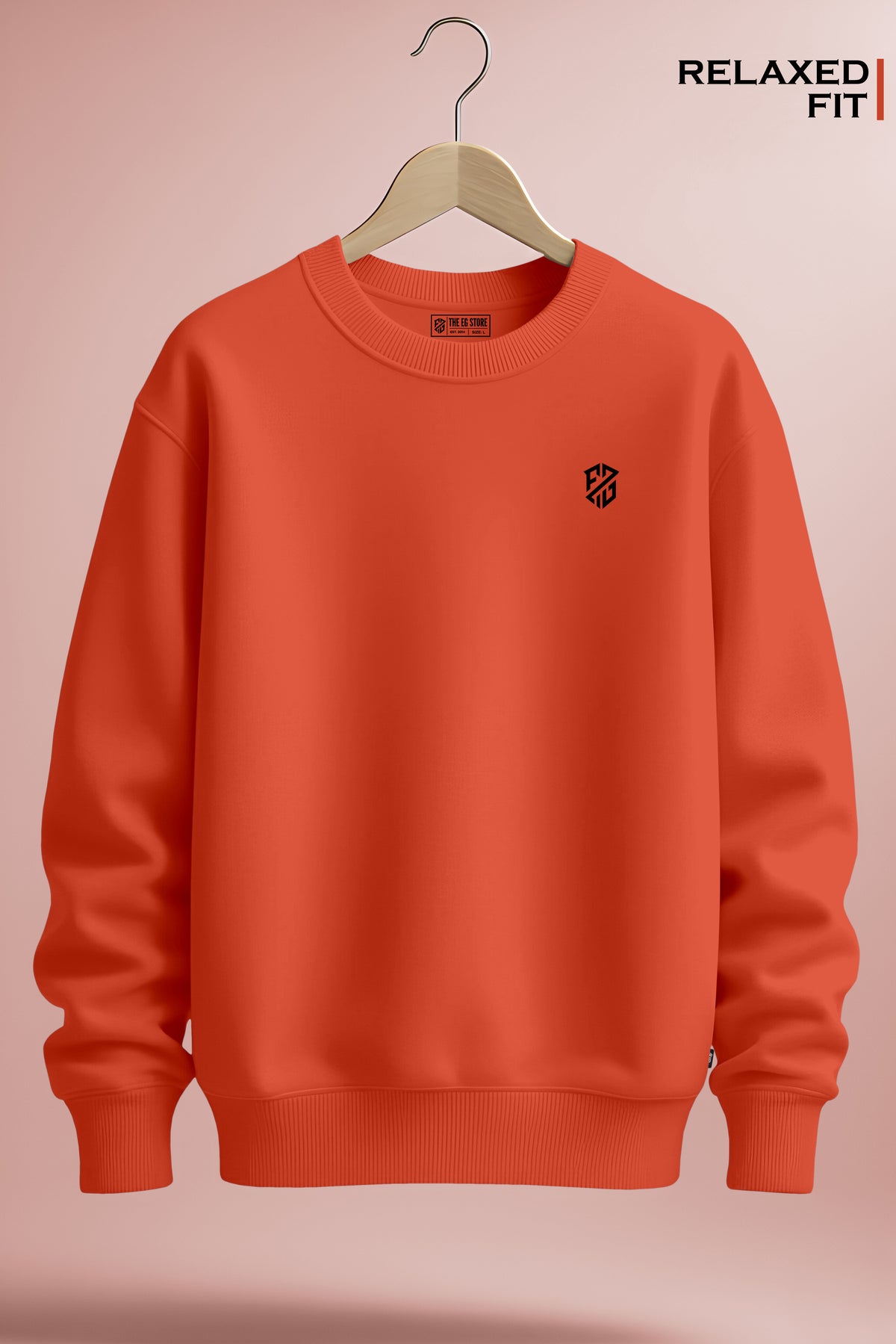 Relaxed fit orange crewneck sweatshirt with minimalist chest logo on wooden hanger