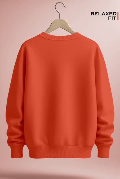 Back view of an orange relaxed fit crewneck sweatshirt on a hanger against a pink background.