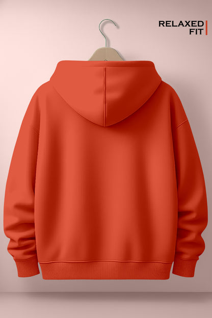 Back view of orange relaxed fit hoodie on hanger against pastel pink wall