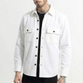 Man wearing a white button-up shirt jacket with front pockets and black pants