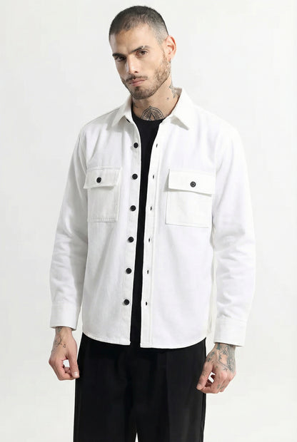 Man wearing a white button-up shirt jacket with front pockets and black pants
