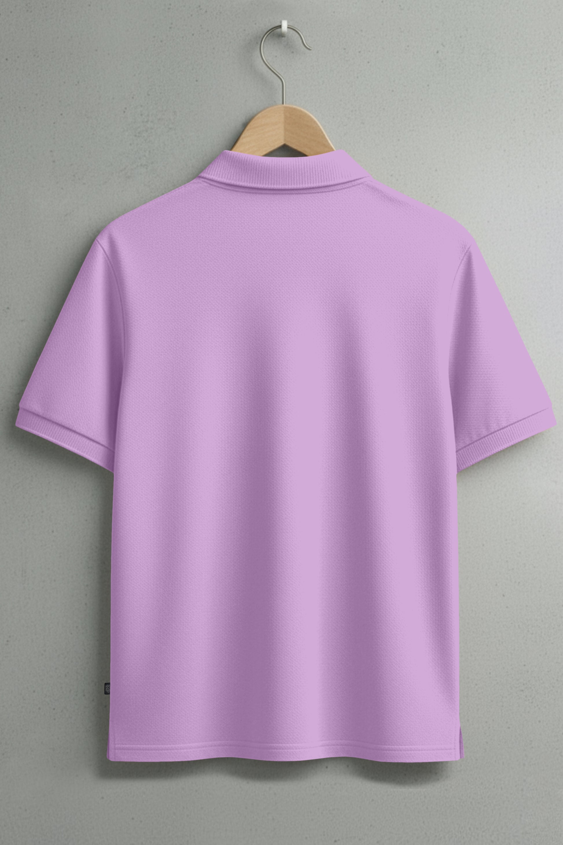 Back view of a plain light purple polo shirt on hanger against a gray wall
