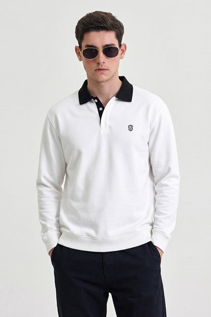 Man wearing white long sleeve polo shirt with black collar and sunglasses