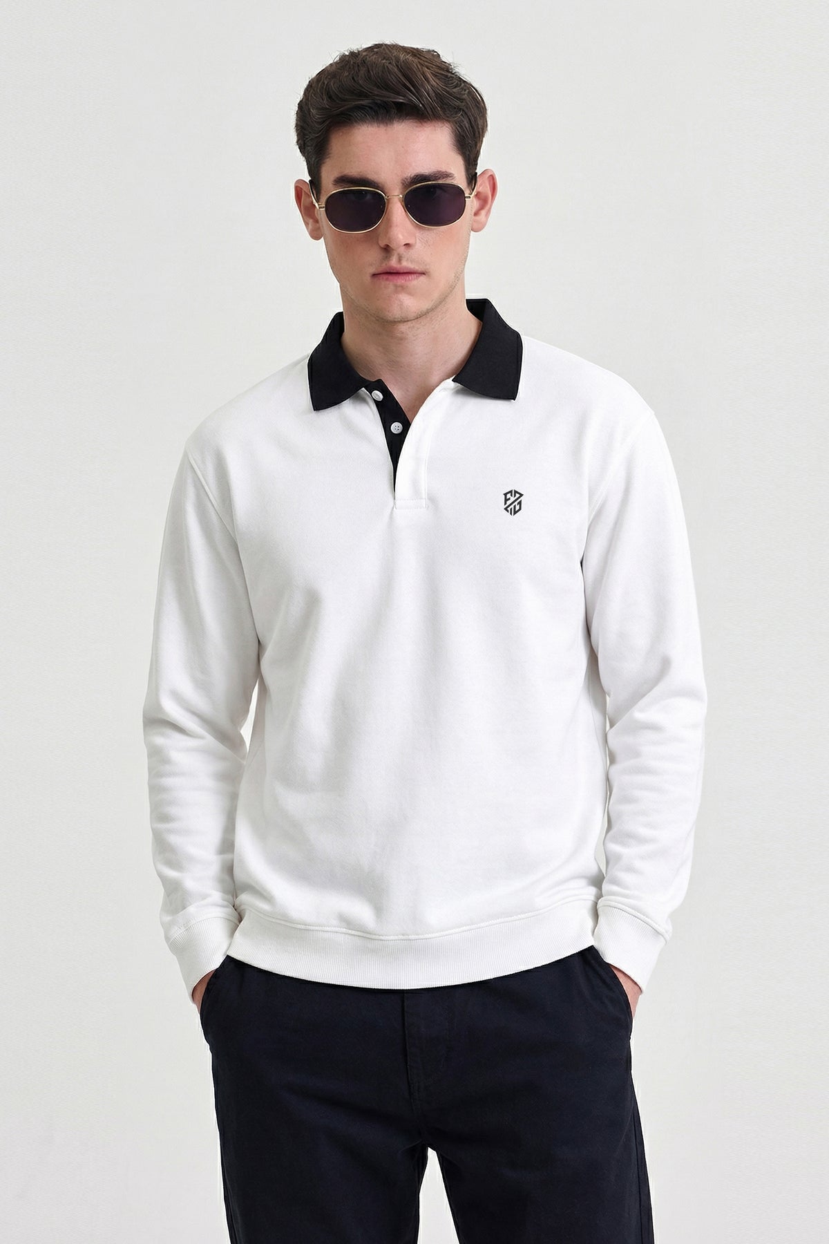 Man wearing white long sleeve polo shirt with black collar and sunglasses