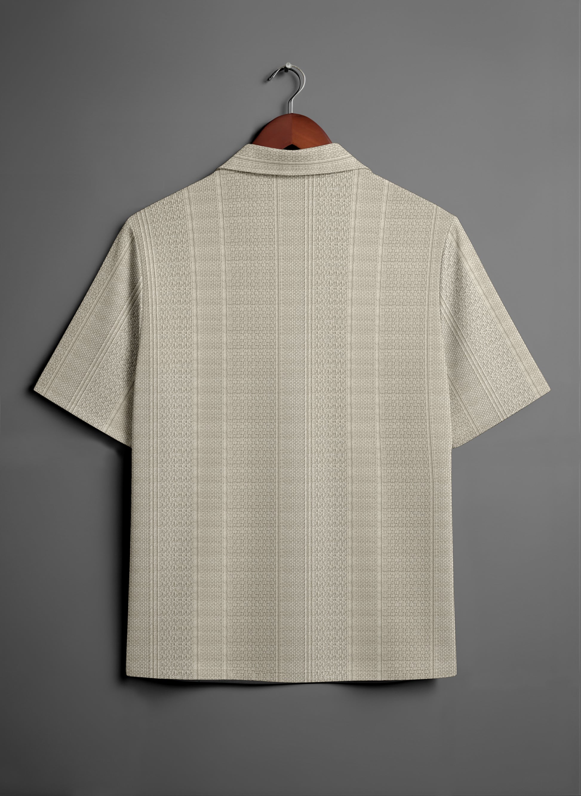 Beige textured short sleeve shirt on hanger against gray background, back view