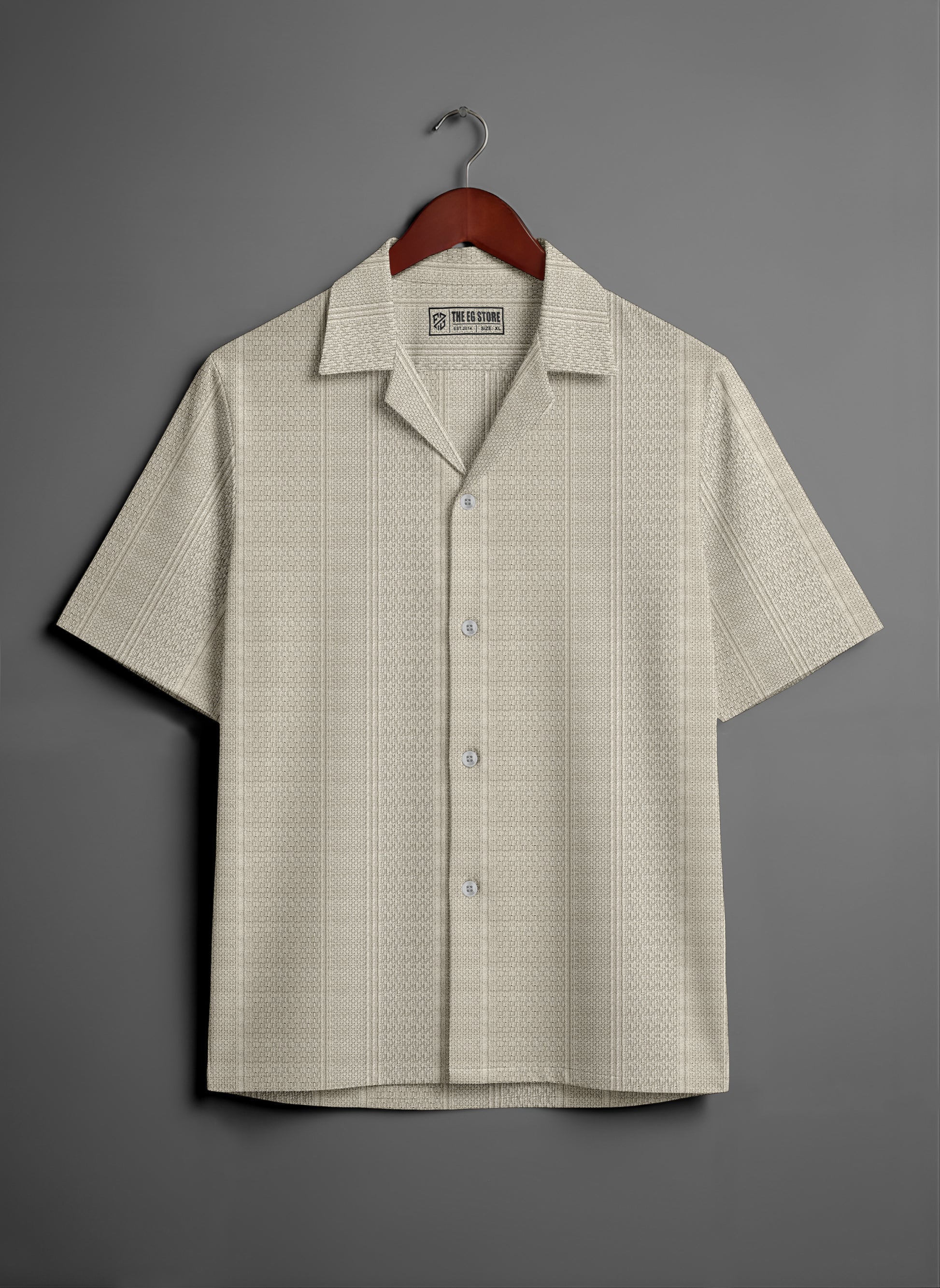 Beige short sleeve button-up shirt with subtle textured pattern on hanger, grey background