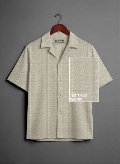 Beige short sleeve button-up shirt with textured fabric on wooden hanger