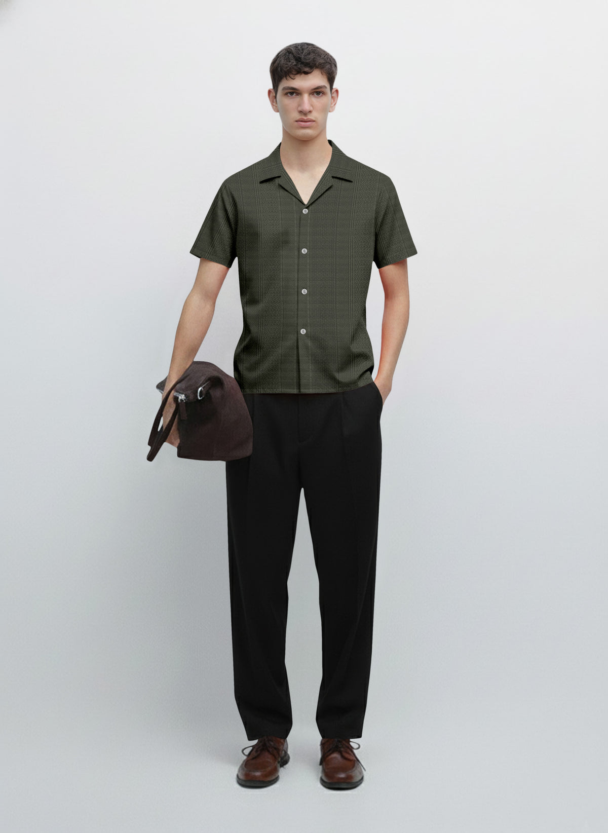 Man wearing short sleeve button-up shirt, black trousers, brown shoes, holding bag