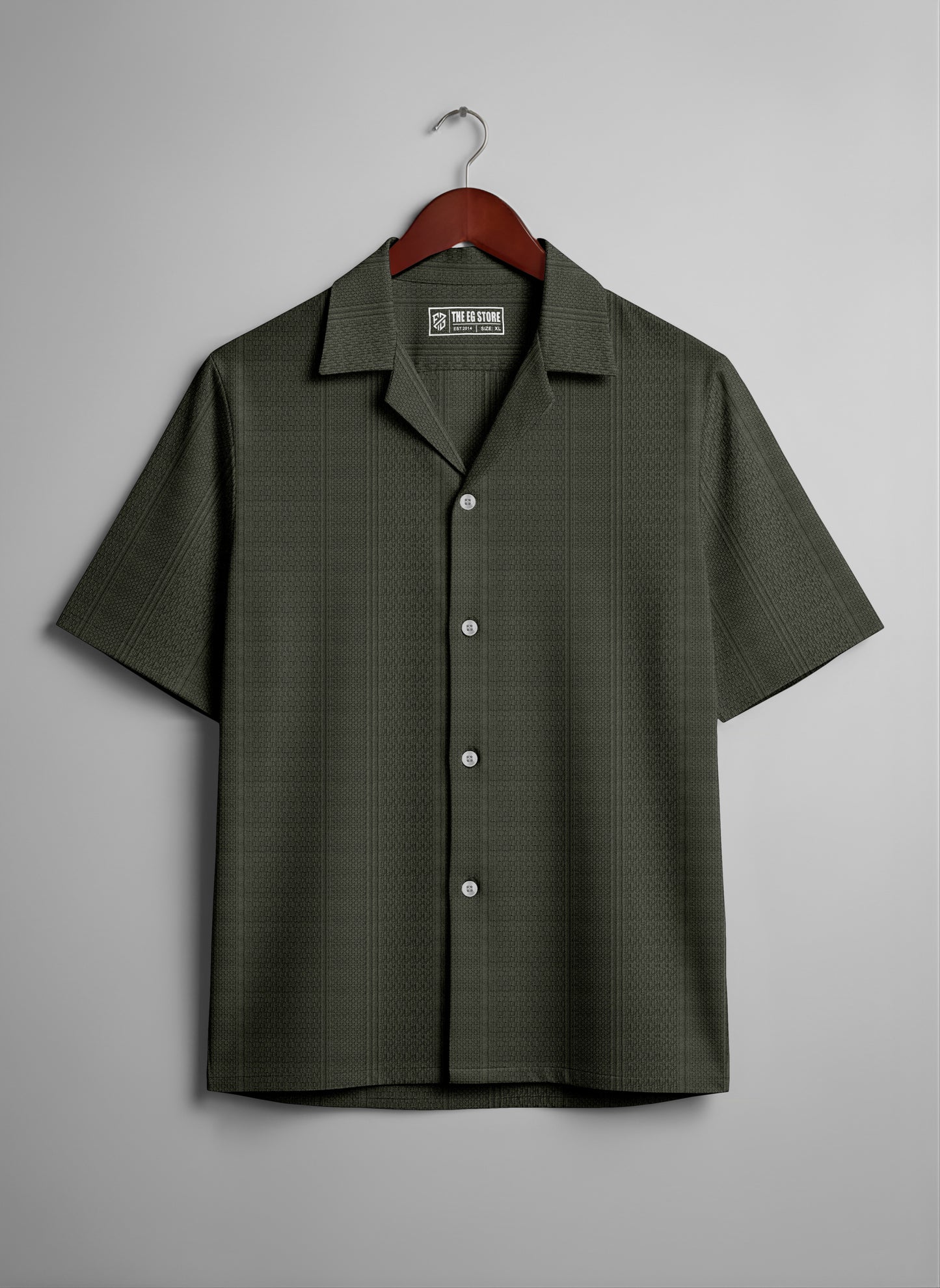 Olive green short sleeve button-up shirt with subtle texture, hanging on a wooden hanger.