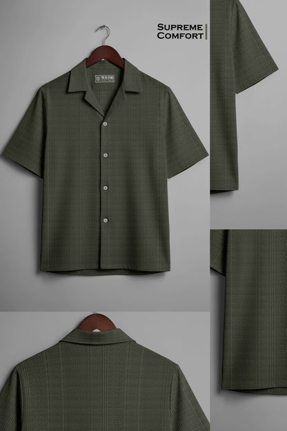 Olive green short-sleeve button-up shirt with subtle pattern, labeled supreme comfort