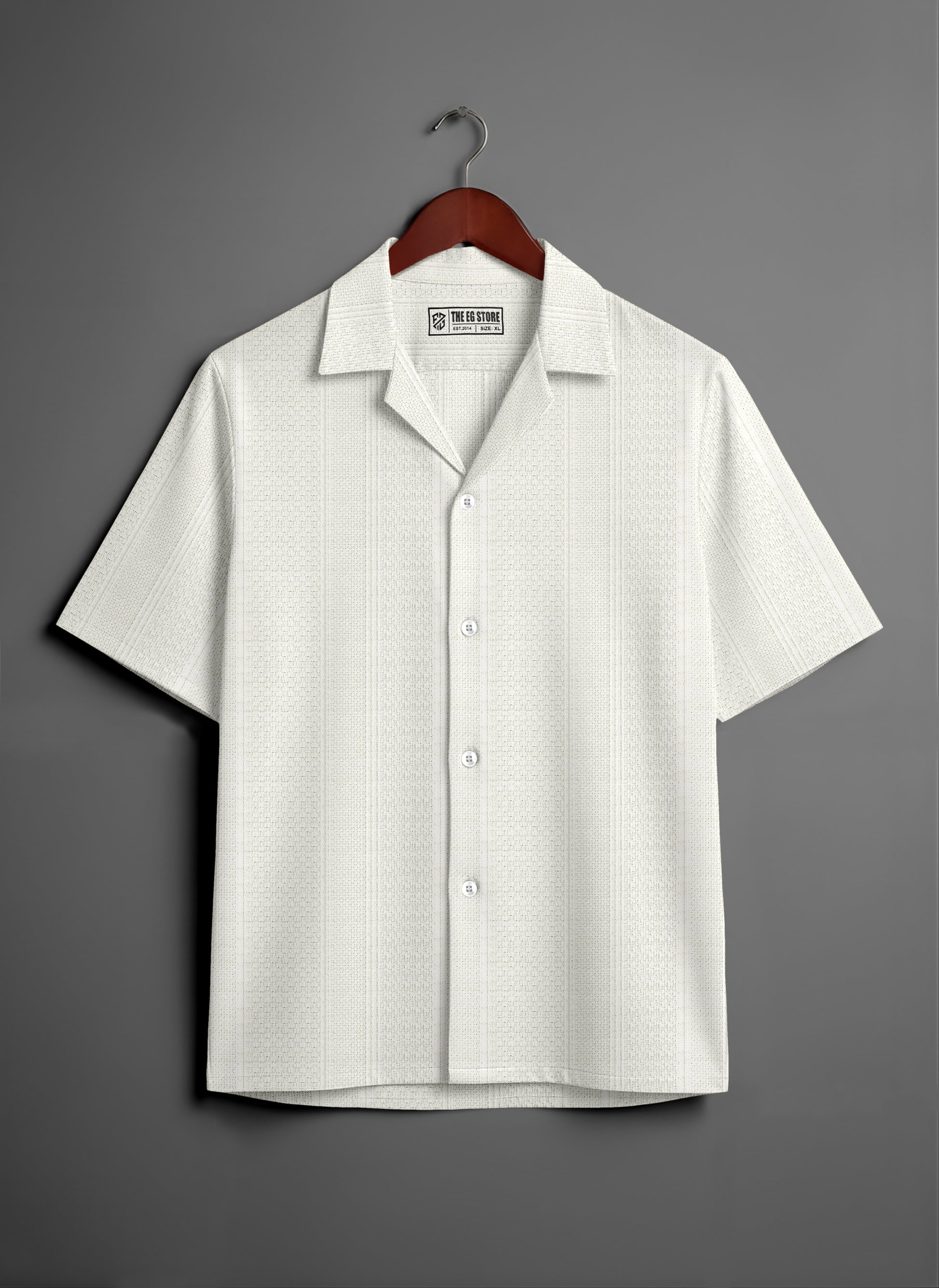 White short sleeve button-up shirt with subtle pattern on wooden hanger