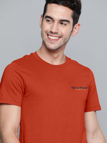 Smiling man in an orange t-shirt with 'New World' text printed on chest
