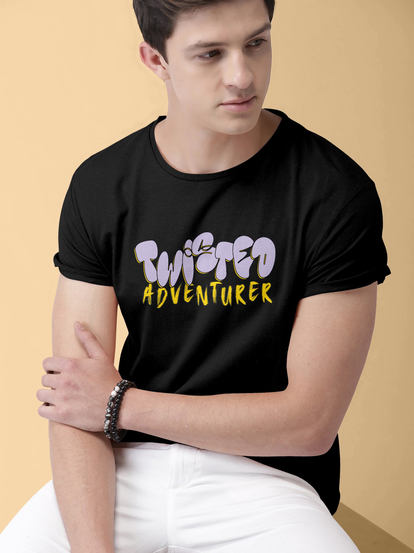 Man wearing black t-shirt with 'Twisted Adventurer' graphic, casual modern style