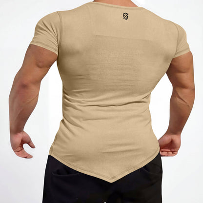 Man wearing fitted beige short sleeve muscle tee with pointed hem, athletic wear
